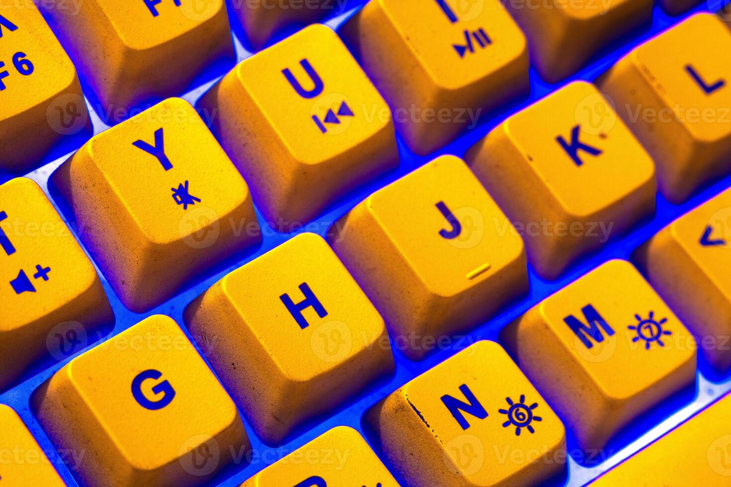 Bright yellow keyboard with blue light ambience photo