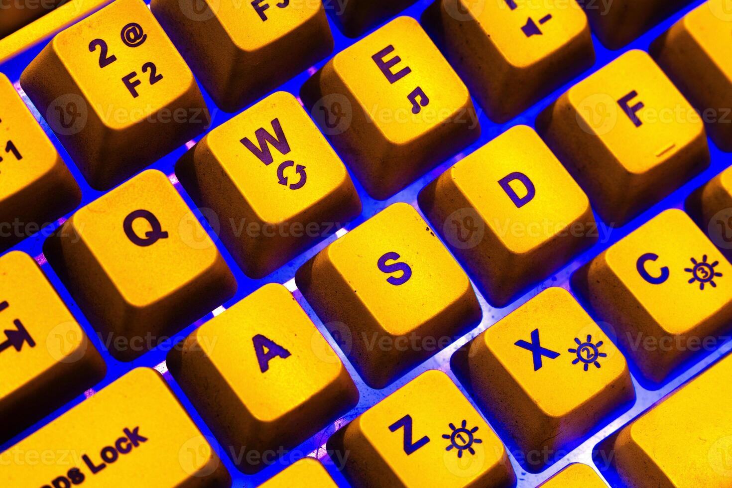 Yellow keyboard with blue light ambience, WASD Keyboard keys photo