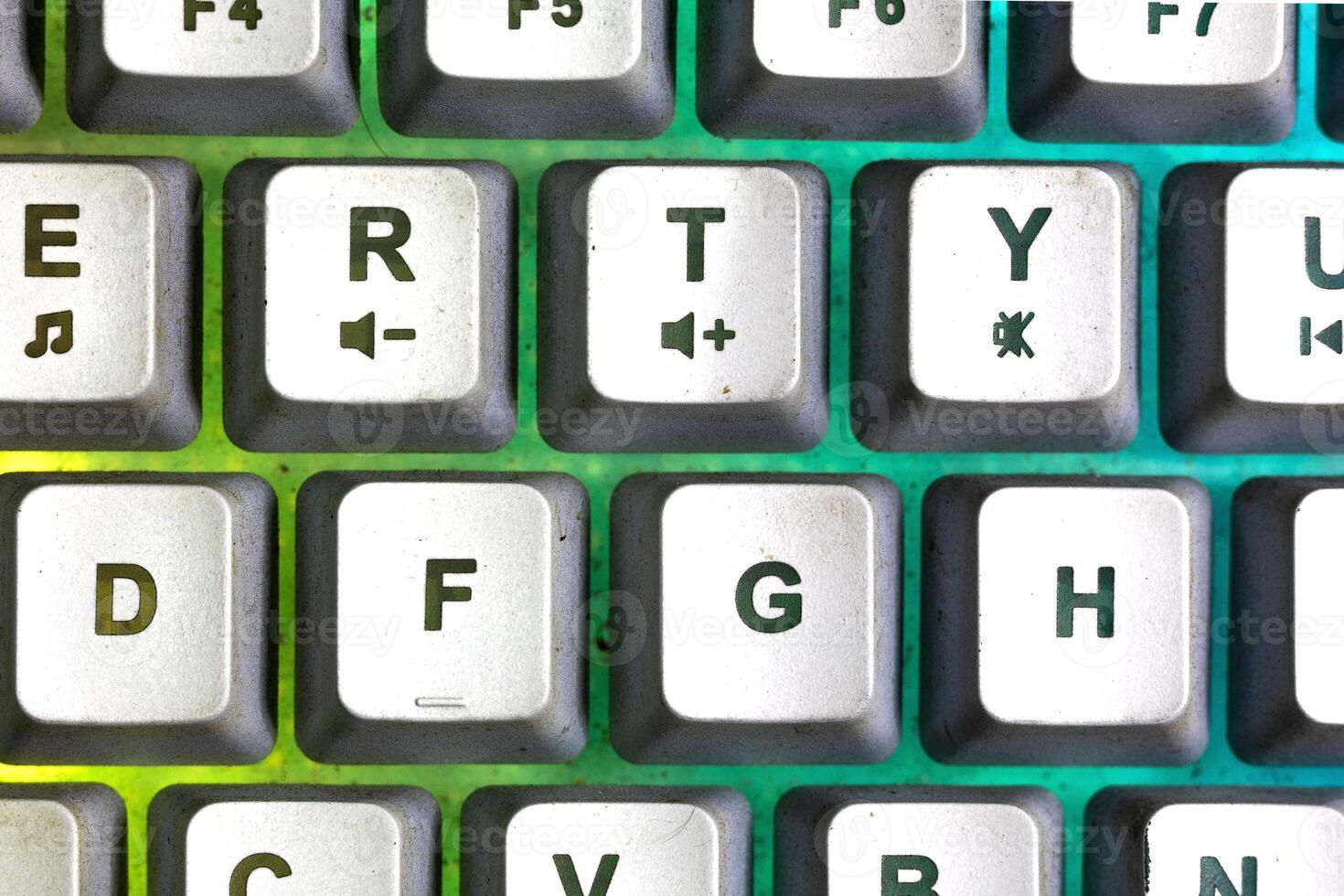 Detail photo of keyboard key with yellow and green color back light