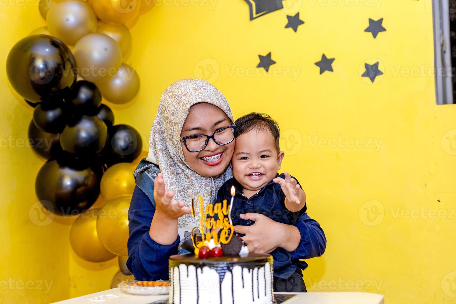 Loving Mother with Her Baby Boy on His First Birthday. Single mom and her son smiling together photo