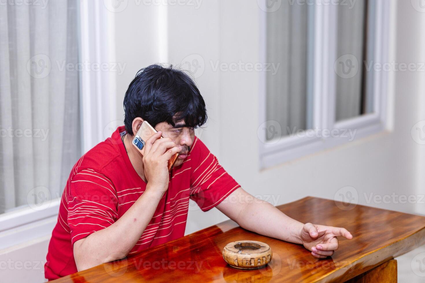 Man Having a Serious Phone Conversation. Intense Discussion Over a Phone Call. photo
