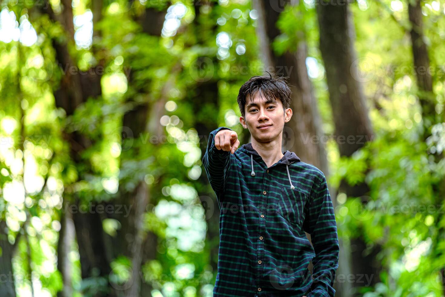 Handsome man standing and pointing at you, Young men challenge you to step outside. photo