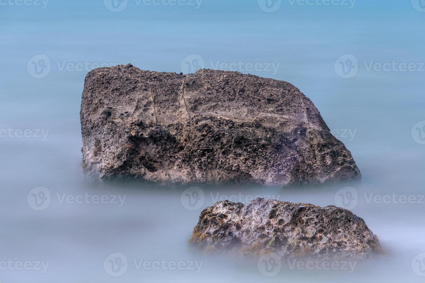 Rocks formation at the beach. Beautiful long exposure rocks in the sea. photo