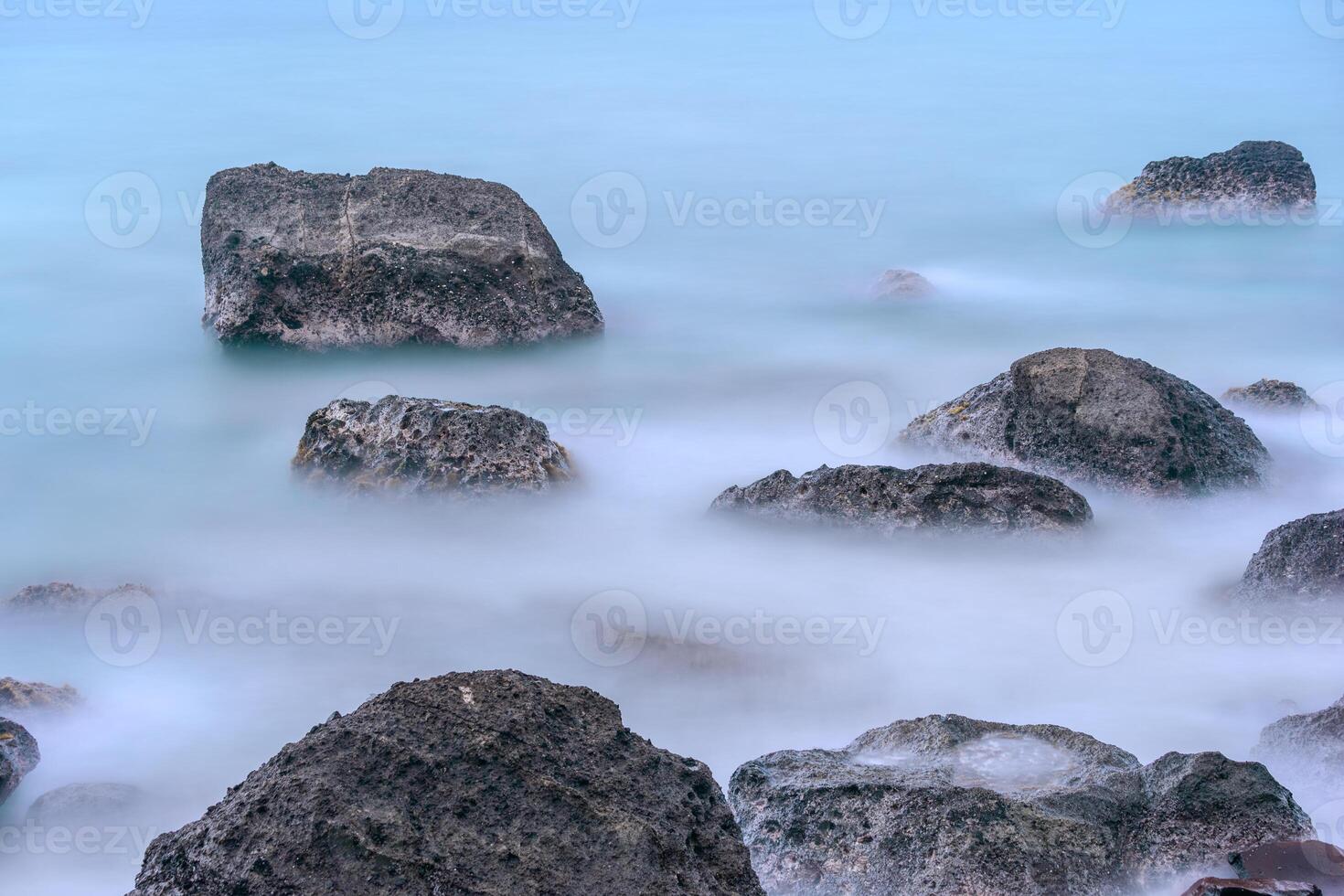 Rocks formation at the beach. Beautiful long exposure rocks in the sea photo