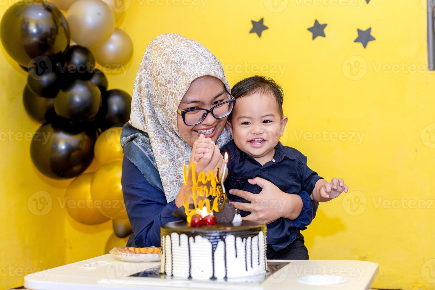 Celebrating her first birthday with joy and smile. Birthday party with colorful decoration, cakes and balloon photo