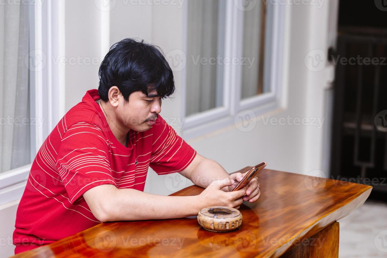 Man Concentrating on His Smartphone. Serious Moment with a Smartphone in Hand. photo