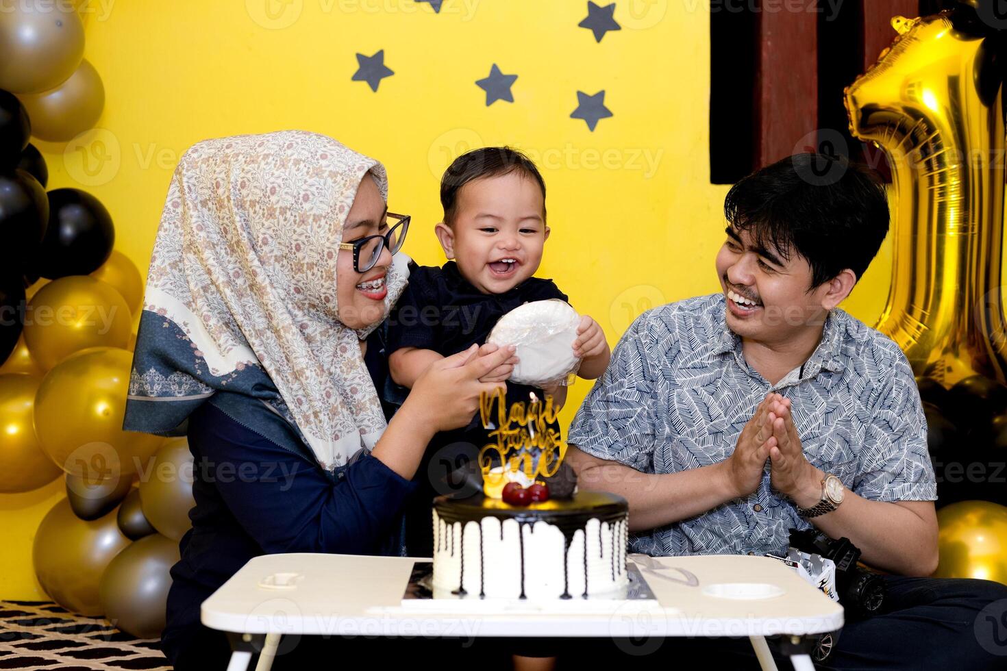 Happy Family Celebrating Their Baby's First Birthday Together. Birthday moments with cake, balloon and cute decoration photo