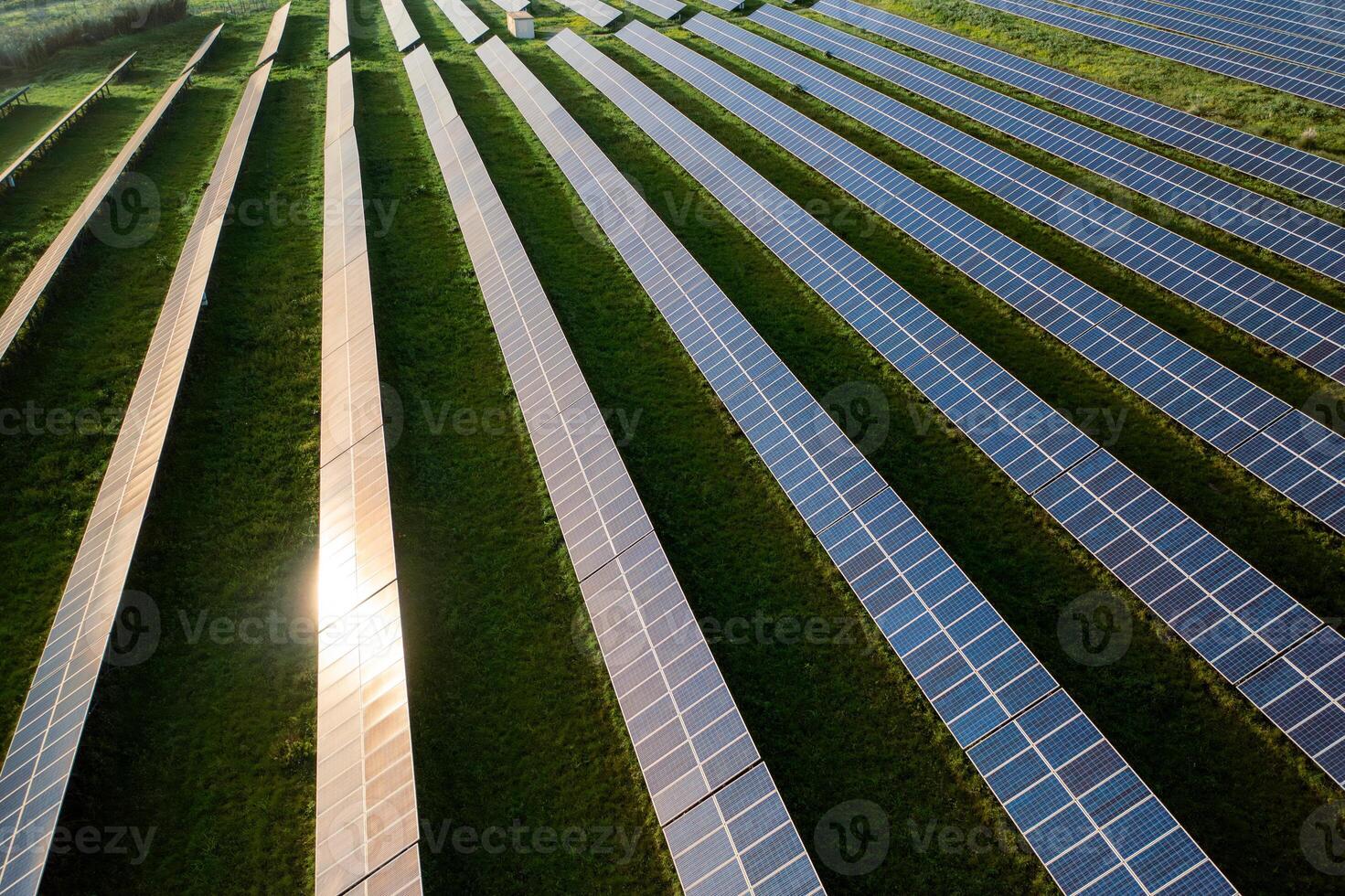 From above shot of sunlight reflecting on solar panels at field photo