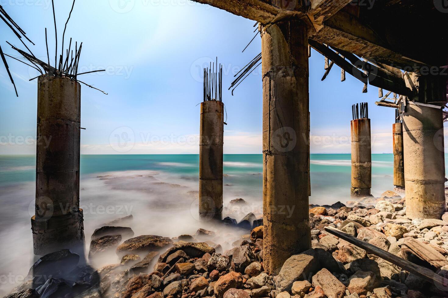 Scenic Coastal View with an Old Bridge Overlooking the Sea. Tranquil Ocean with Shimmering Blue Waves. photo