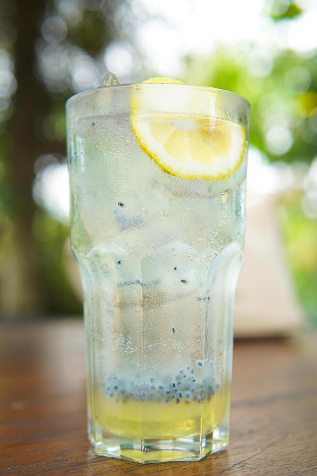 Glass of fresh lemonade squash with basil seed drink close up photo