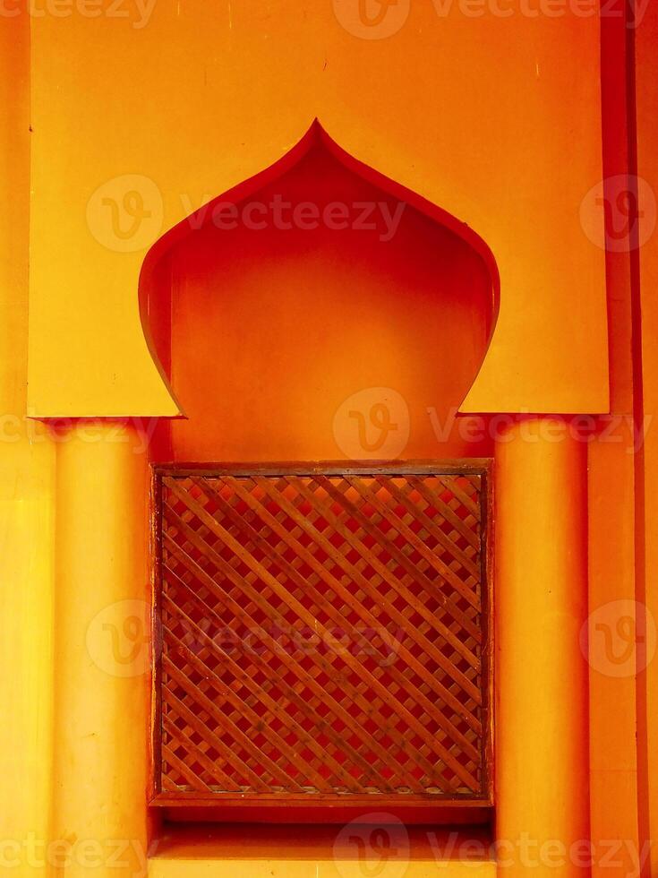 Islamic background architecture. Small archway with a wooden lattice on the inside. photo