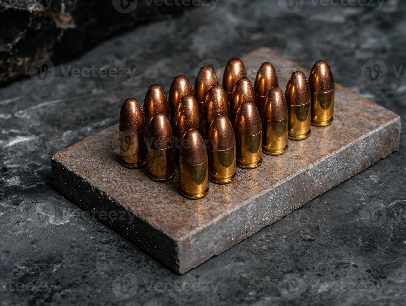Close up of 9mm bullets arranged on a rustic surface photo