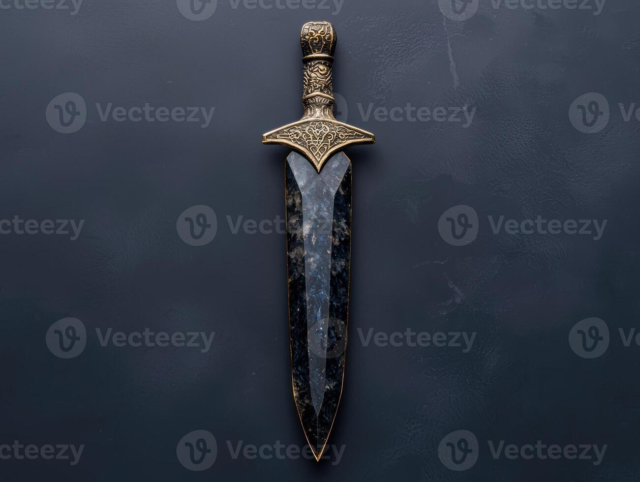 Ornate dagger with dark gemstone blade on dark background photo