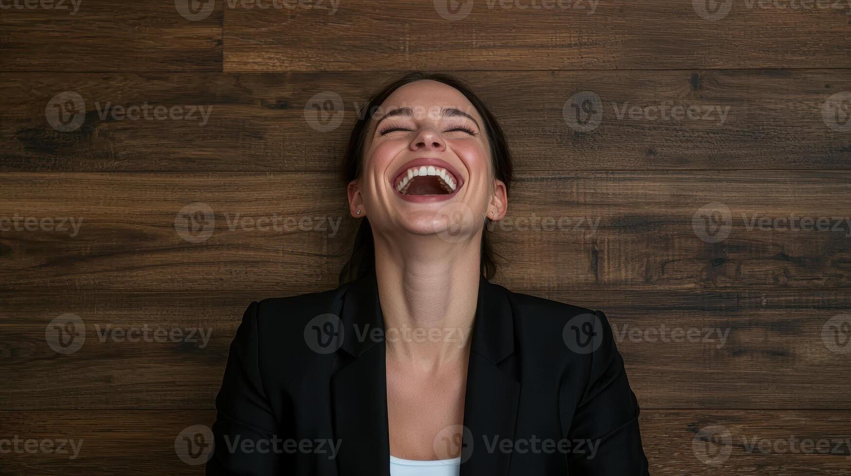 Happy businesswoman laughing with eyes closed photo