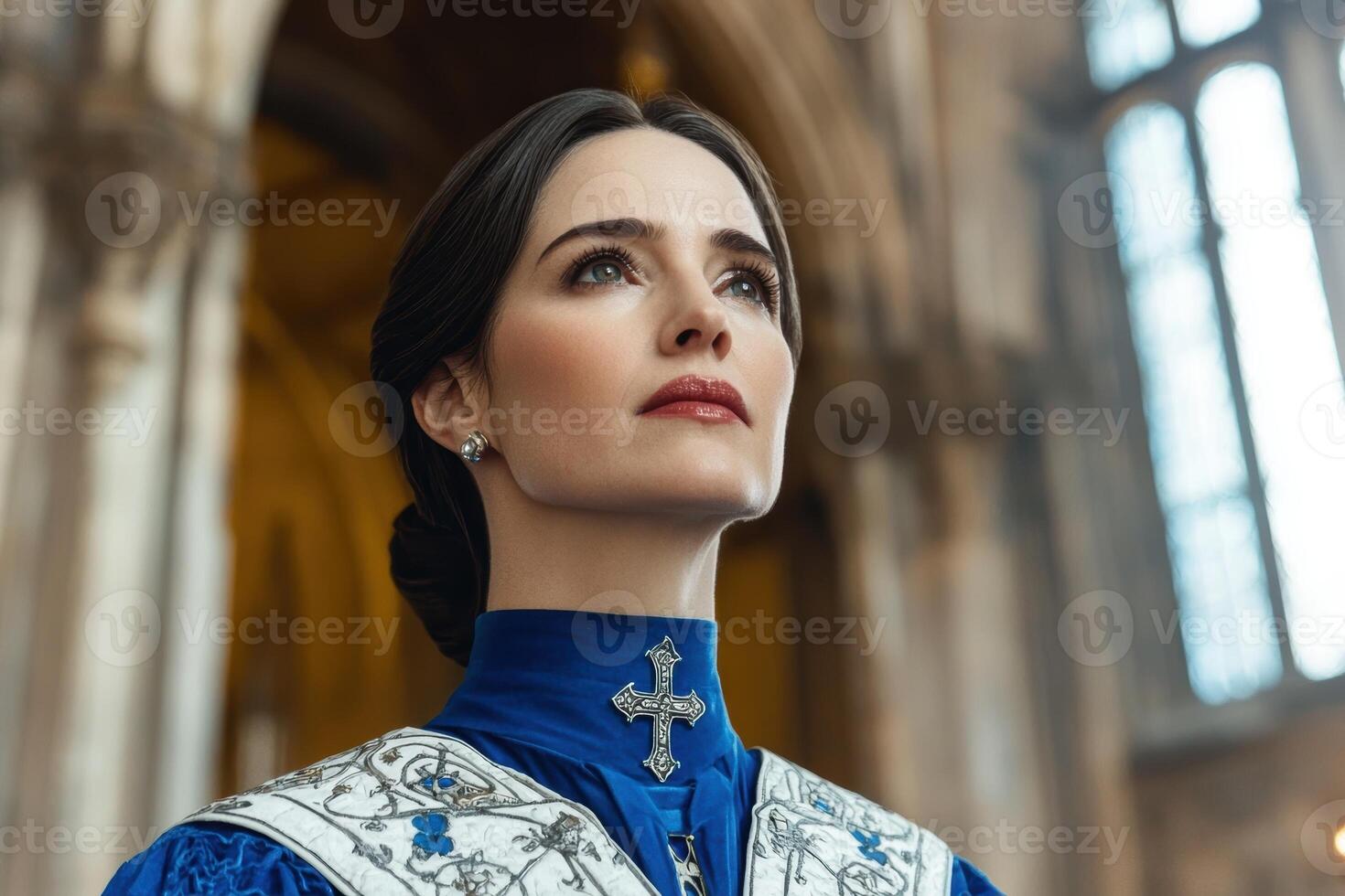 Woman in blue dress looking up in cathedral photo
