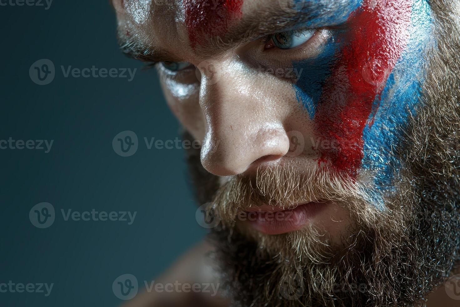 Close up portrait of a man with blue and red face paint photo