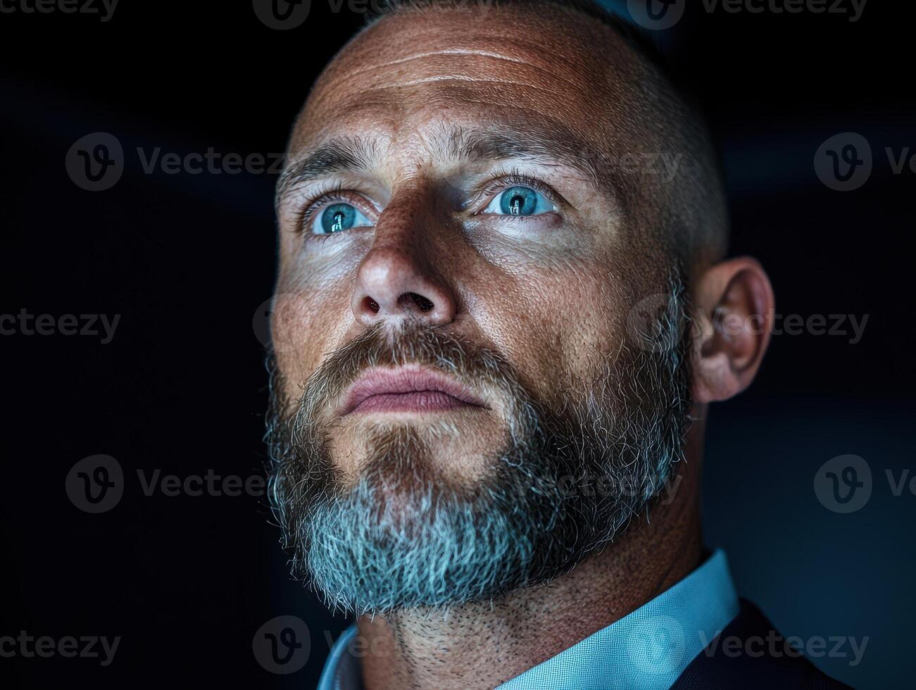 Thoughtful man looking up, contemplative expression photo