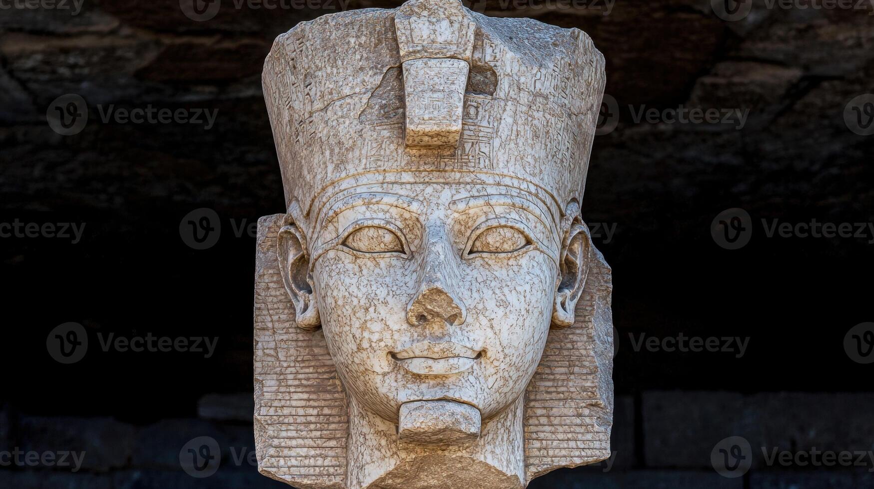 Ancient stone carving of a pharaohs head photo