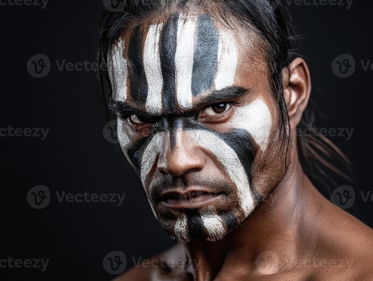 Close up portrait of a man with black and white face paint photo