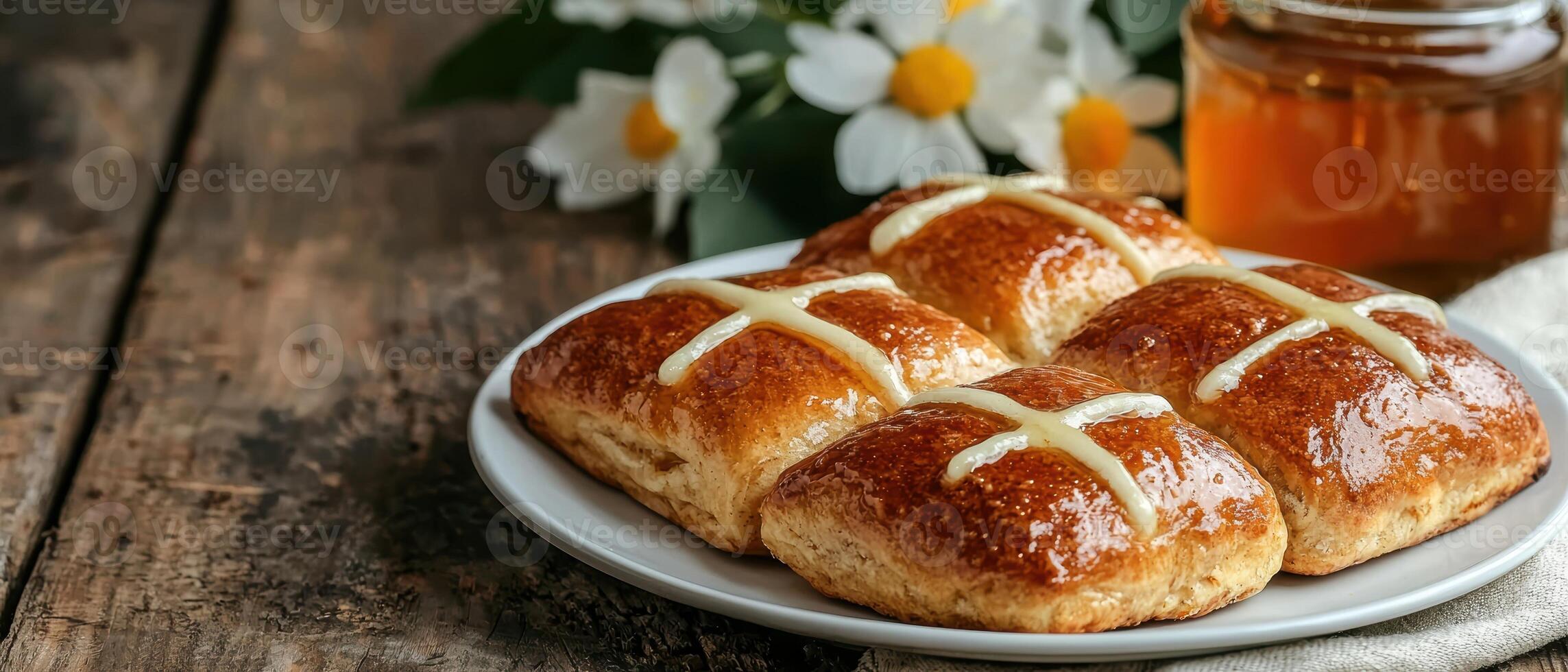 Sweet glazed hot cross buns on a plate photo