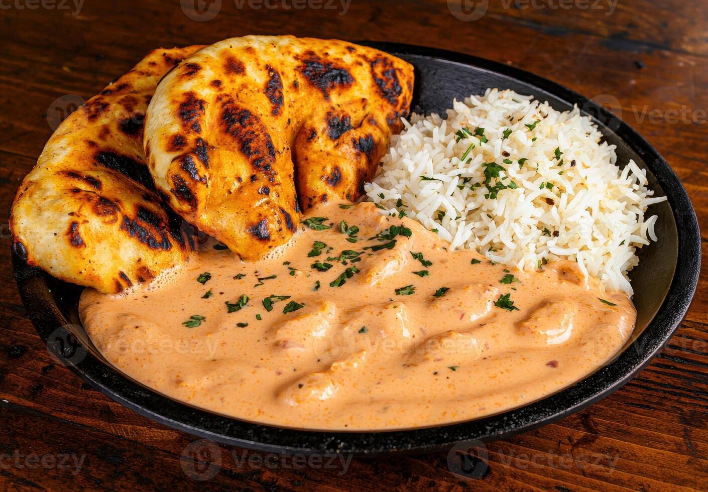 Delicious butter chicken with naan and rice photo