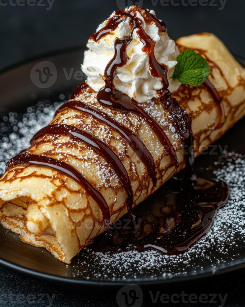 Delicious crepe topped with chocolate sauce and whipped cream. photo