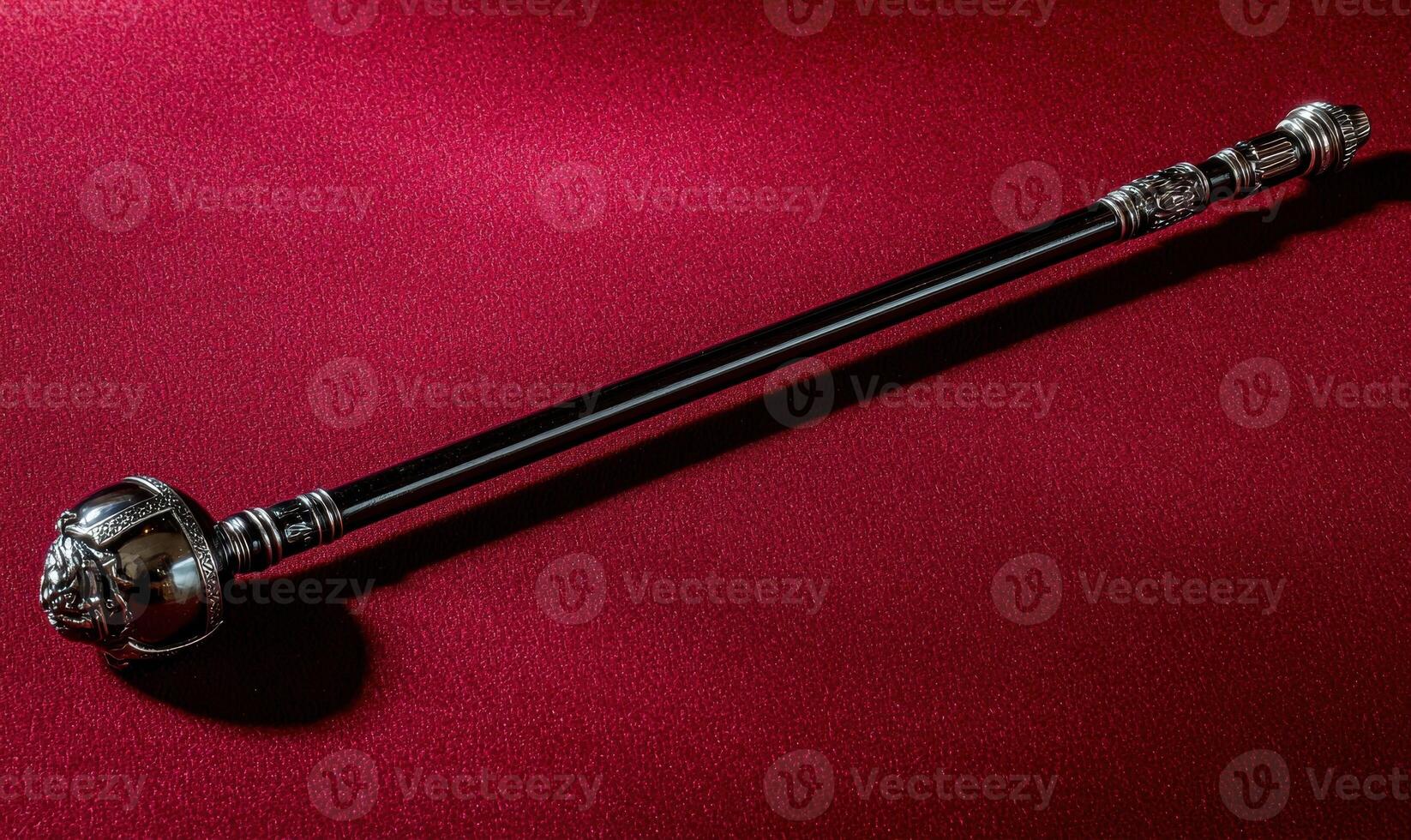 Ornate ceremonial mace on red background photo