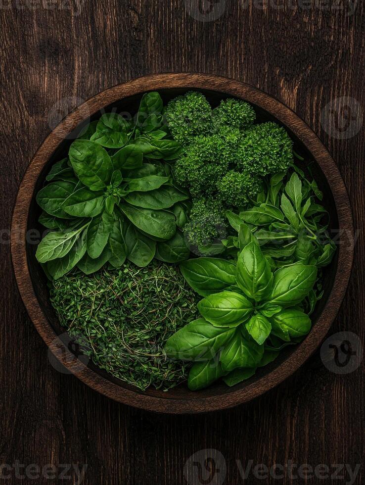 Assortment of fresh herbs in a wooden bowl photo