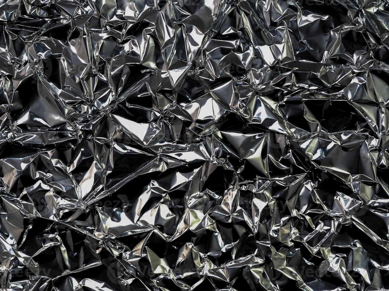 Black silver foil background with crumpled glossy glossy texture for textured background. photo