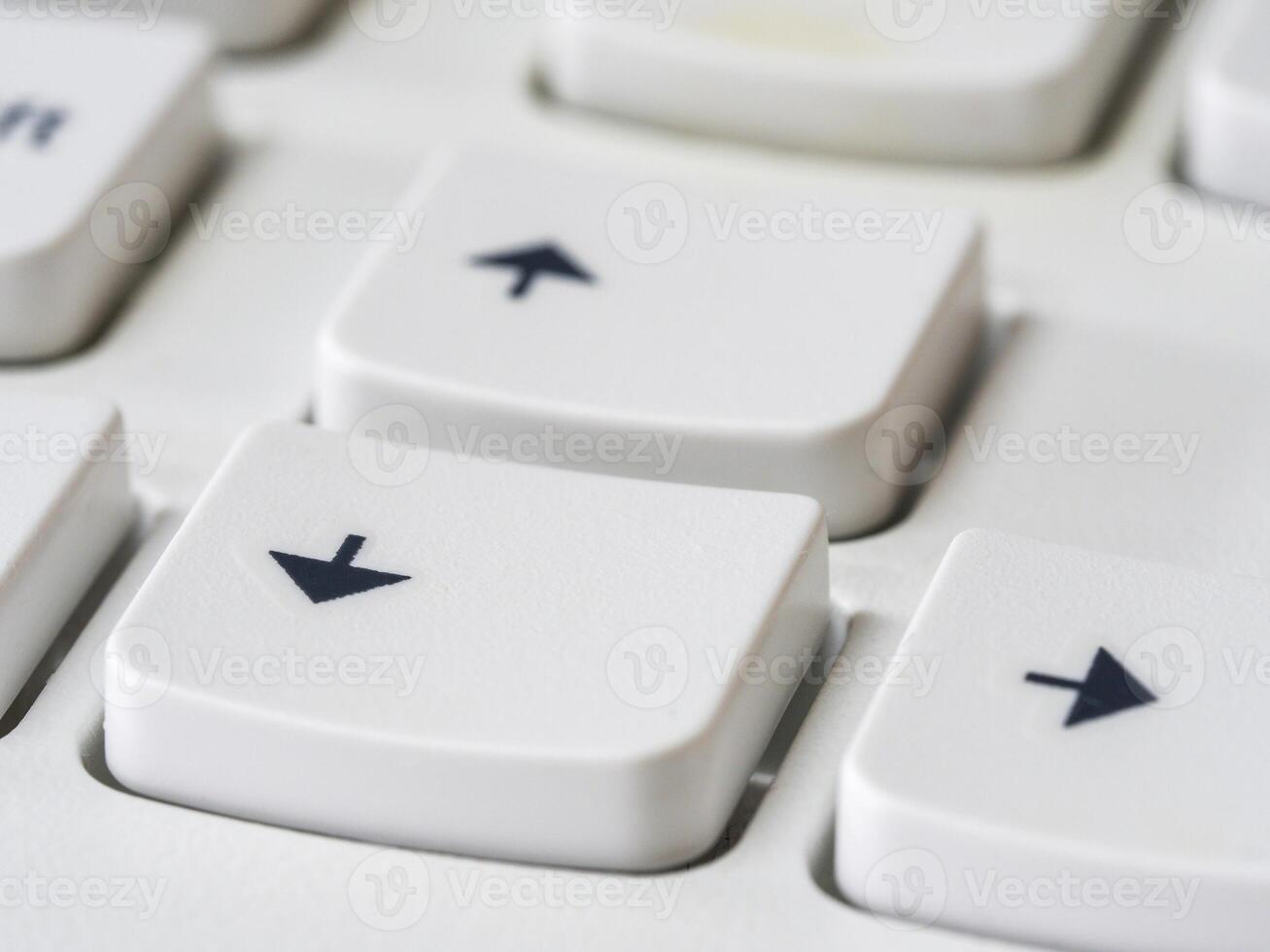 Close up of arrow keys on white keyboard of modern laptop photo