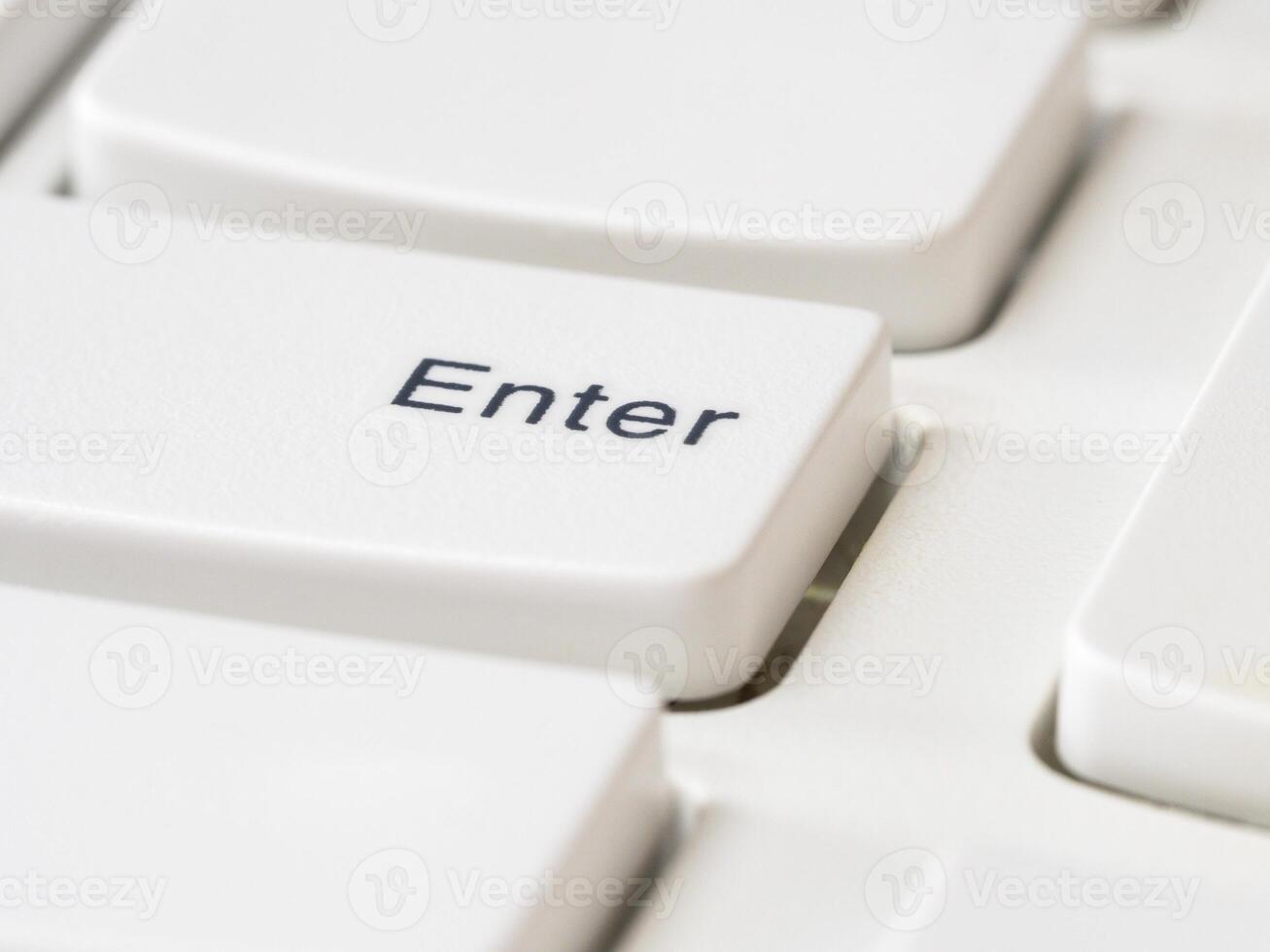 Close up of Enter keys on white keyboard of modern laptop photo