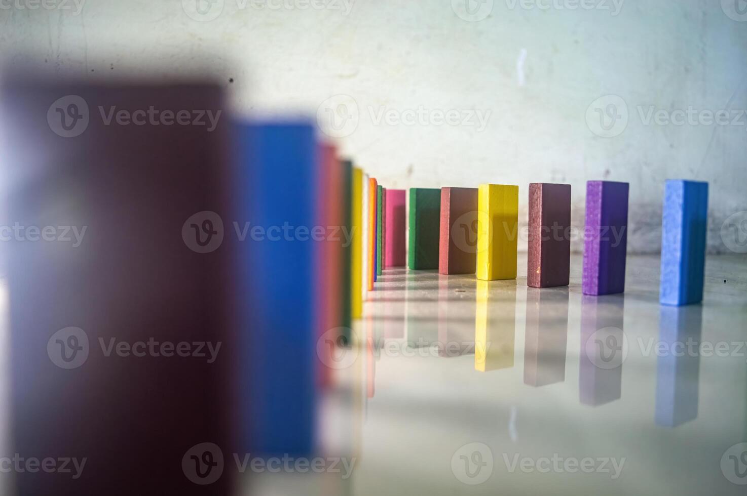 The Colorful wooden blocks in a line on a reflective surface, creating a vibrant pattern photo