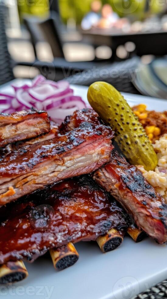 Barbecued beef ribs served with pickles and sauerkraut photo
