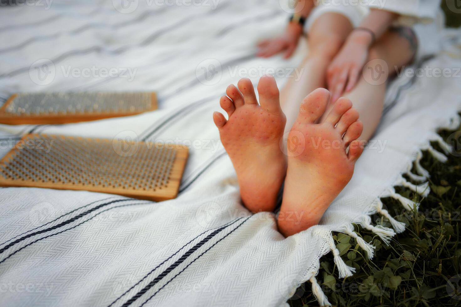 Relaxing afternoon with feet on blanket and tools for foot care in nature photo