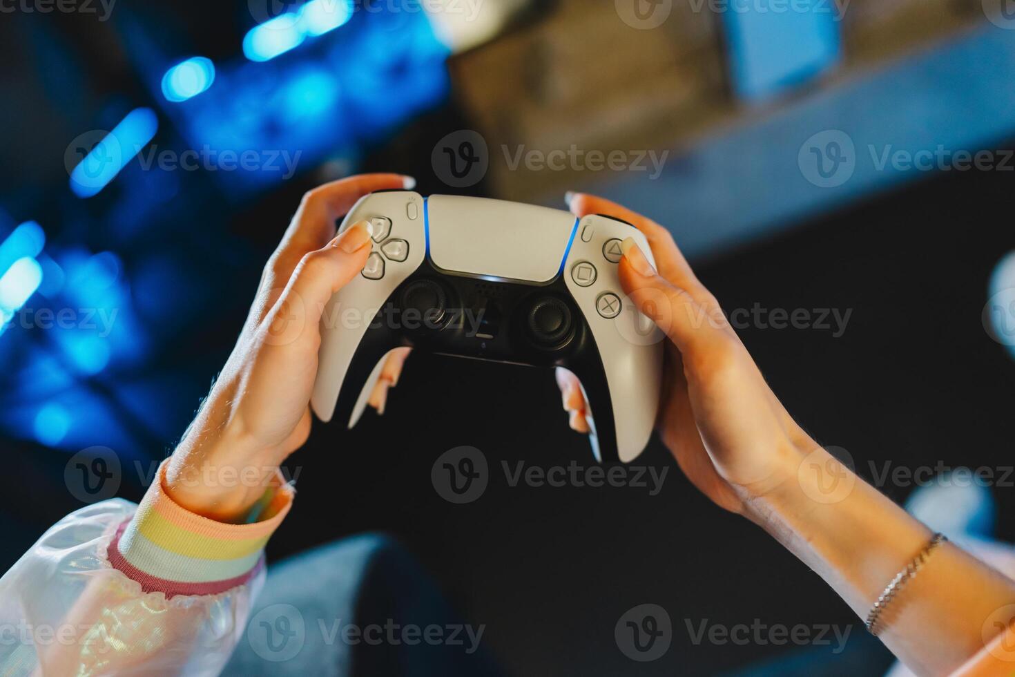 Portrait of a young female gamer playing console. photo