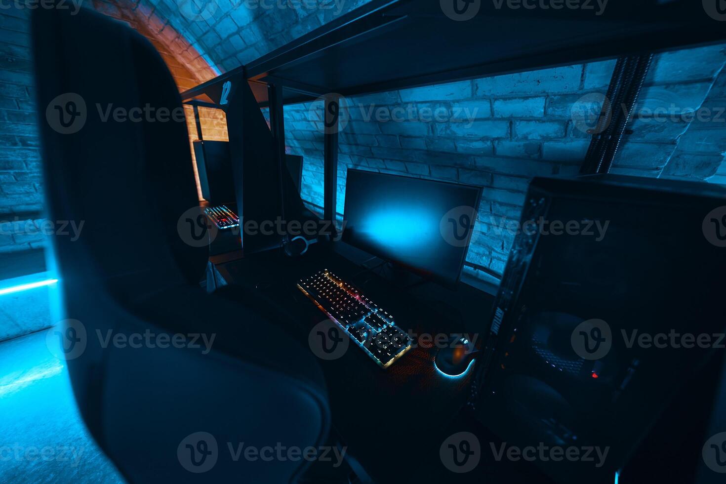 Modern gaming setup with vibrant lighting in a cozy underground room photo