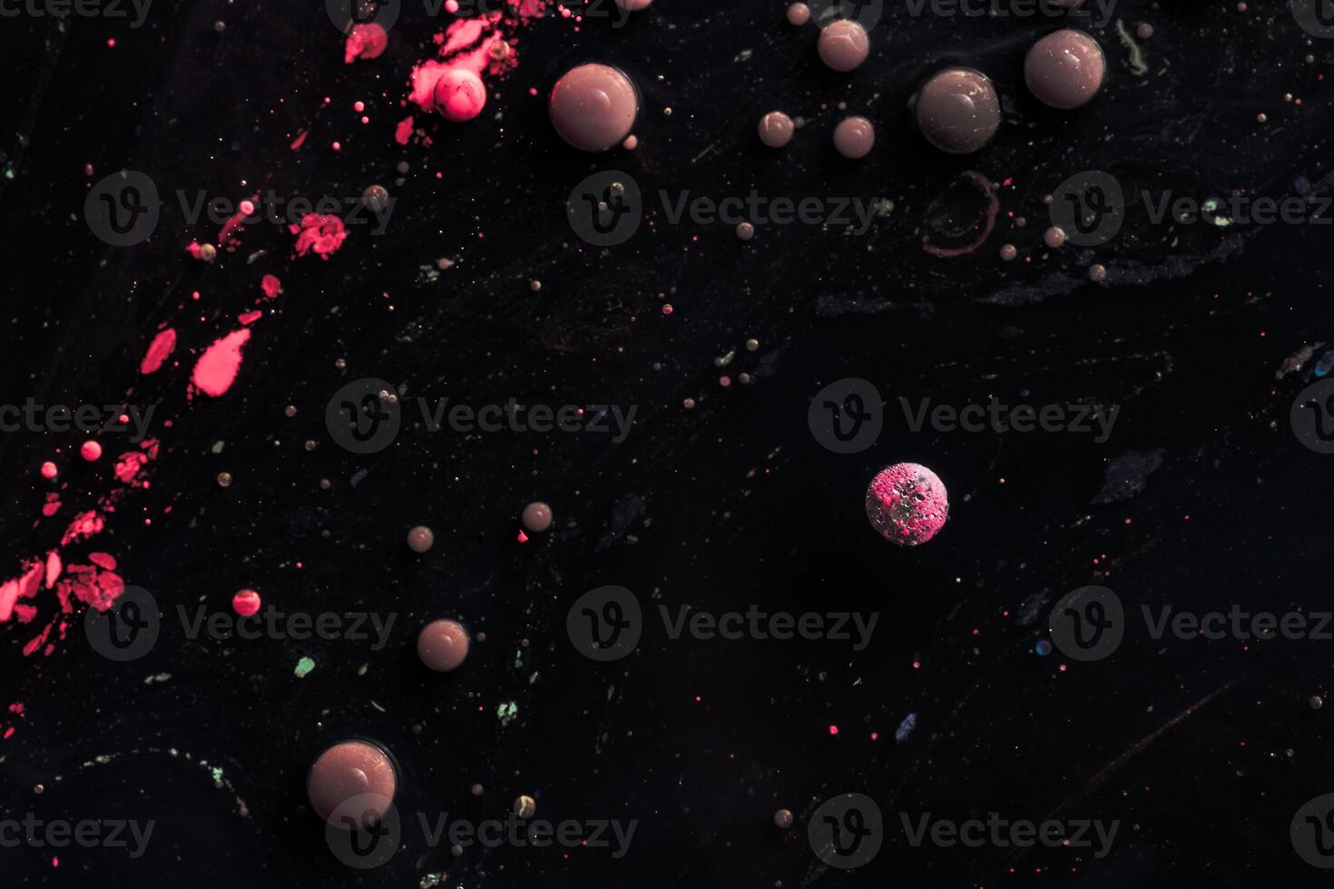 Stains of paint on the water surface. Abstract acrylic bubbles. photo
