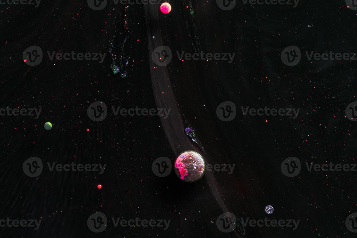 Paint in water. Amazing macro photography in the form of space and planets. photo