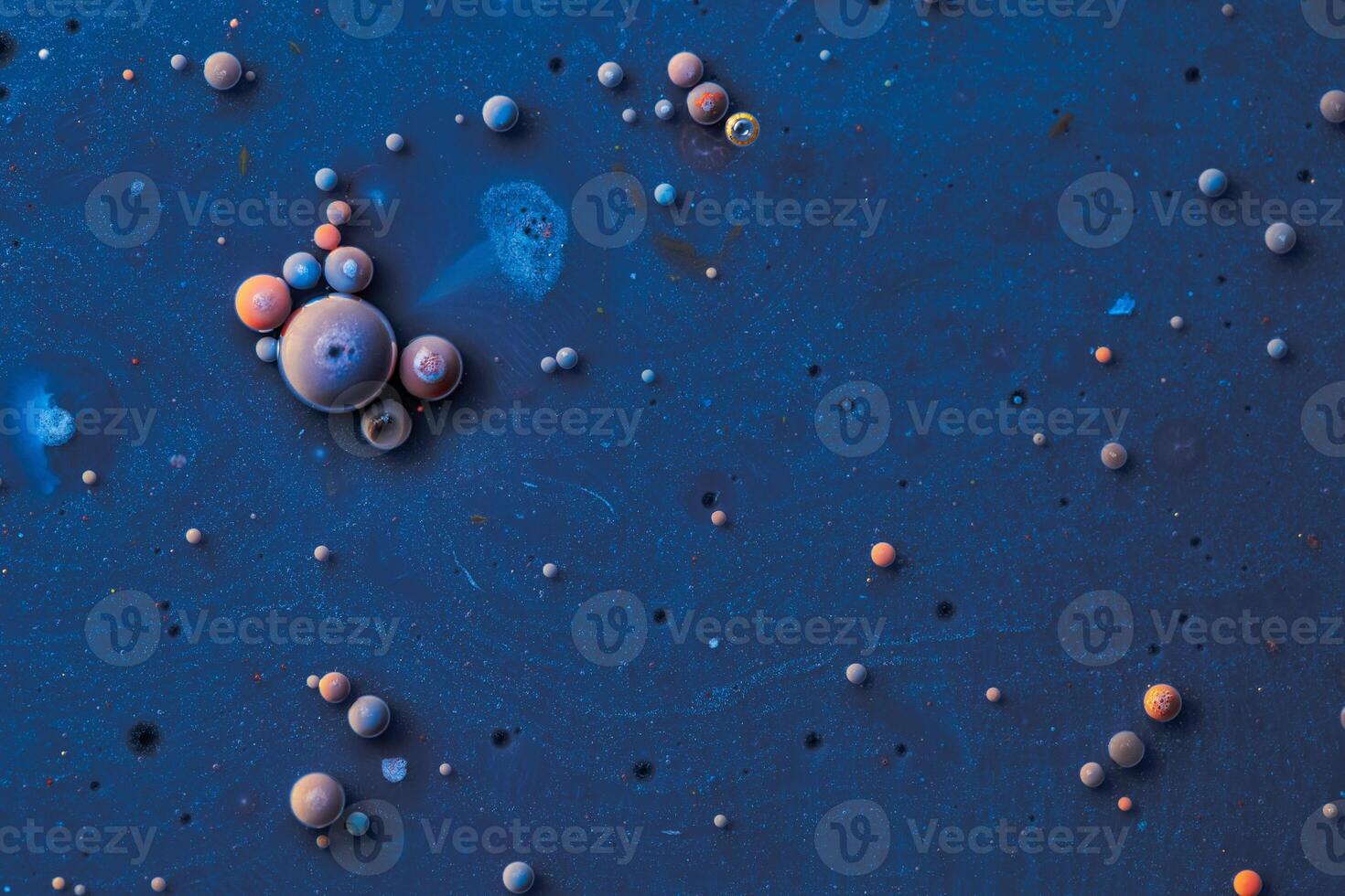 Color drops floating in oil and water over a colorful underground with oil painting effect. photo