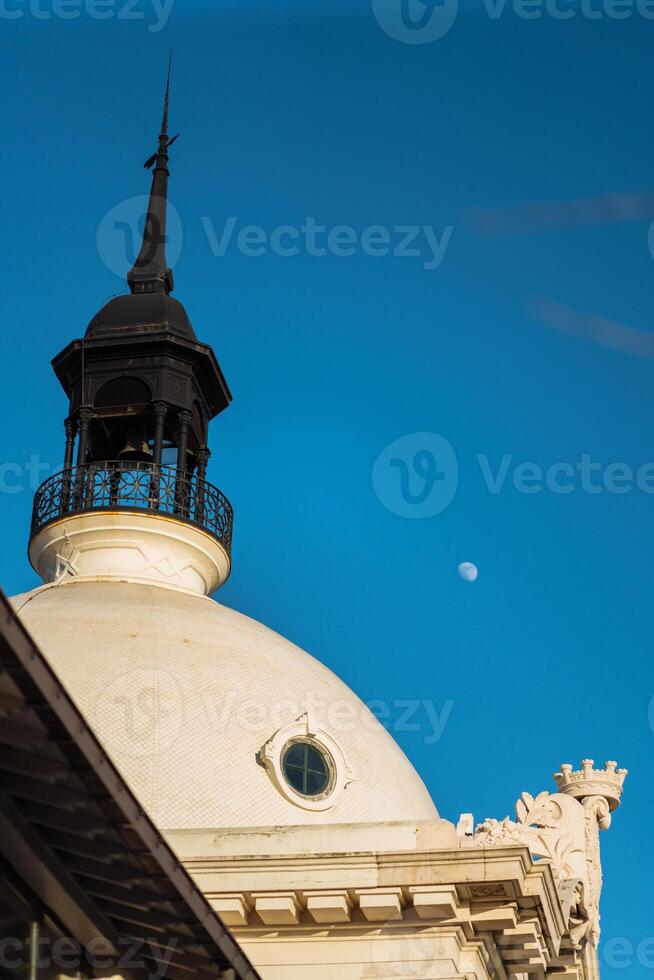 Historical building dome under clear sky with moon visible photo