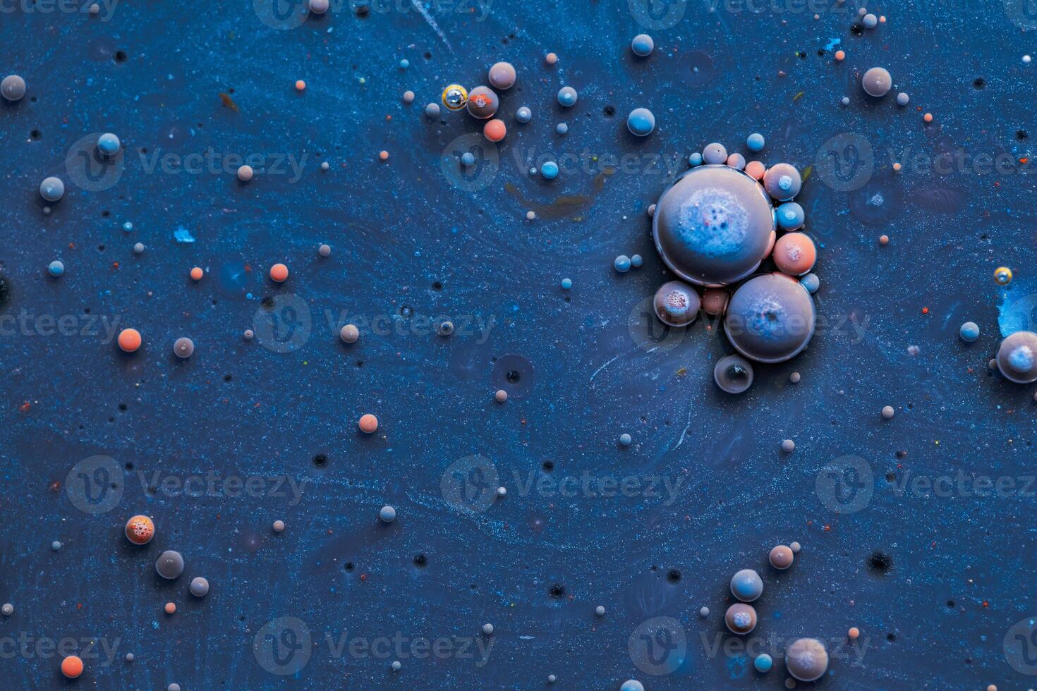 Color drops floating in oil and water over a colorful underground with oil painting effect. photo
