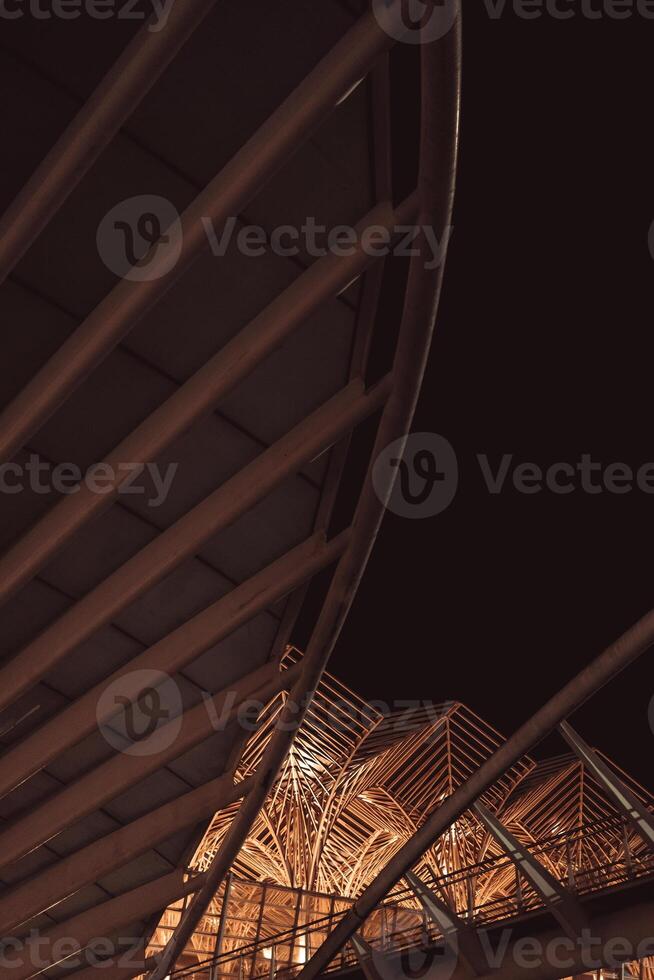 Unique architectural design highlighted by night lighting in urban environment photo