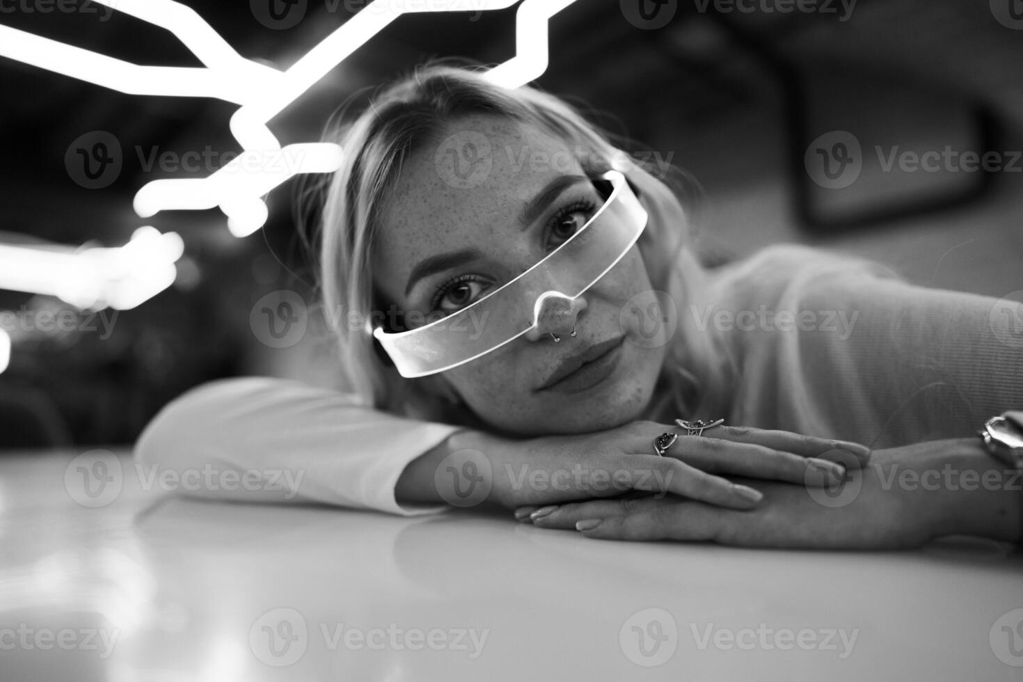 Young woman in neon glasses. Futuristic blonde. photo