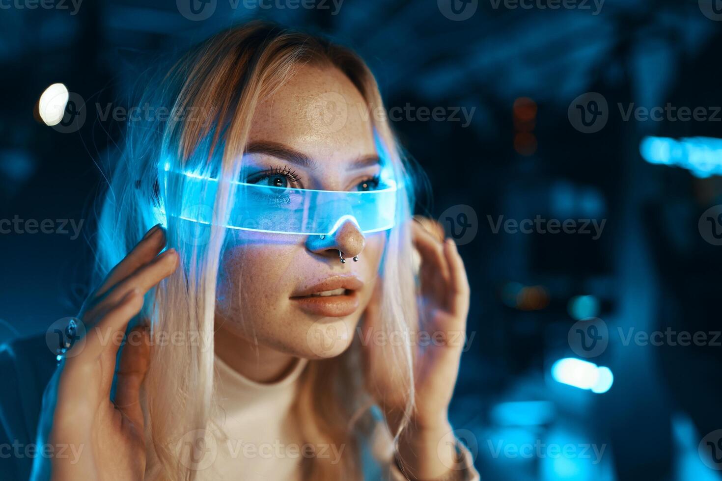The young woman is all dressed in white and wearing neon glasses. Neon style. Portrait of a blonde in fashionable glasses. photo