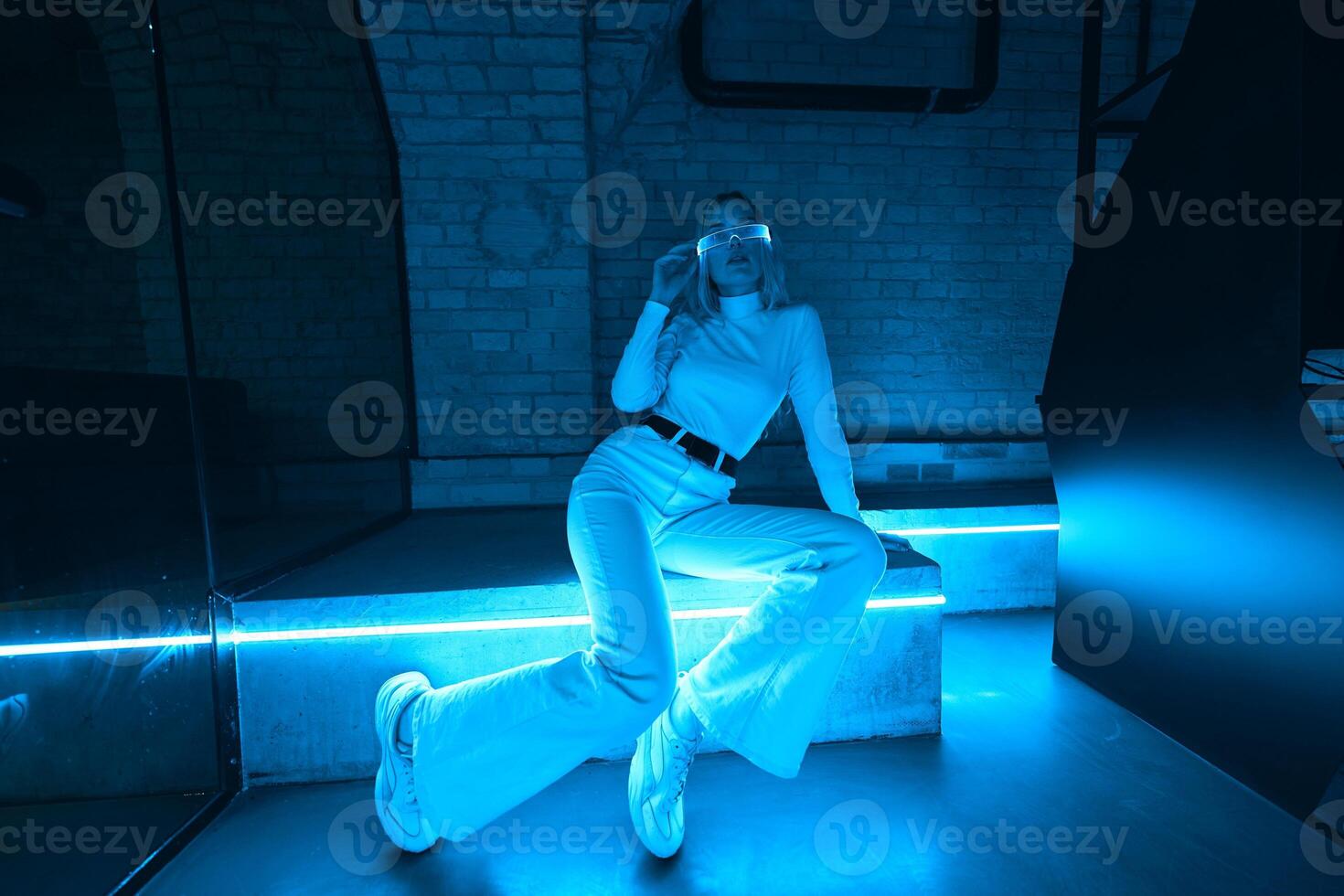 Young woman in neon glasses. Cyberpunk style. photo