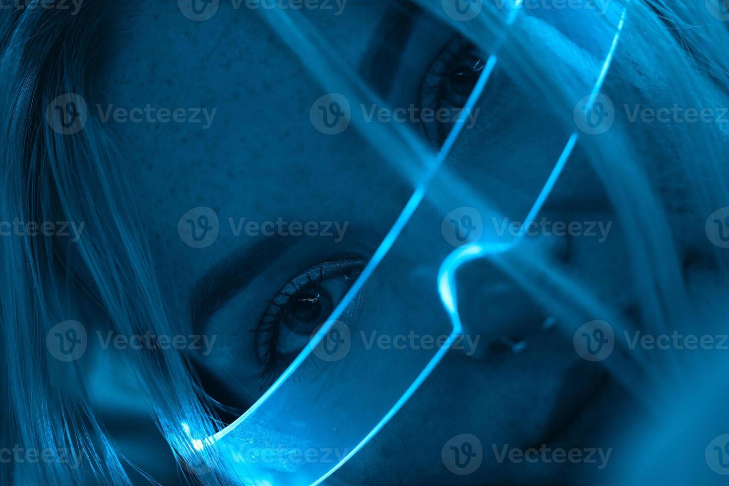 Young woman in neon glasses in futuristic style. photo