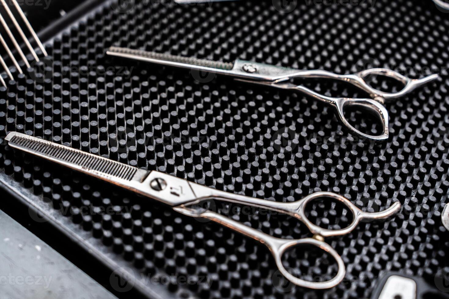 Professional hair cutting scissors displayed on a textured surface for styling photo