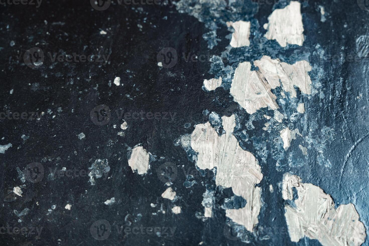 Texture of peeling paint on a dark surface with a unique pattern photo