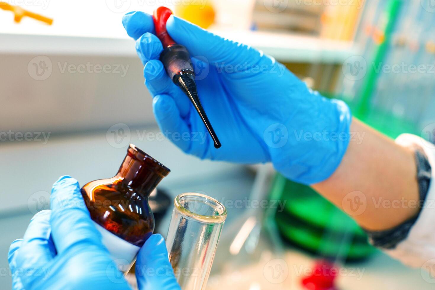 Lab technician conducts an experiment using pipette and glass vial in a laboratory setting during daytime photo