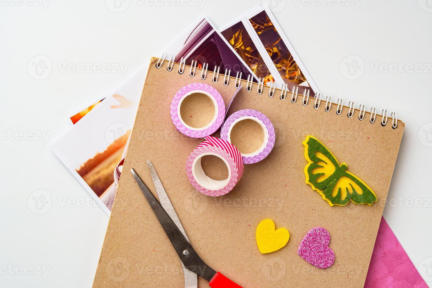 Craft supplies arranged on a table with colorful tape, scissors, and decorative paper cutouts ready for creative projects photo